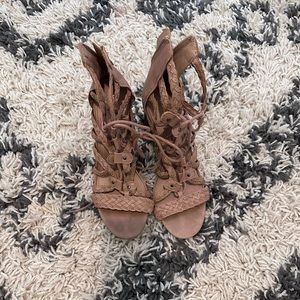 Strappy heeled sandals. They tie as well as zip in the back